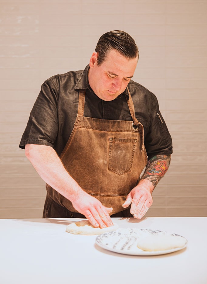 Head chef at Hudson & Nash preparing fresh pizza