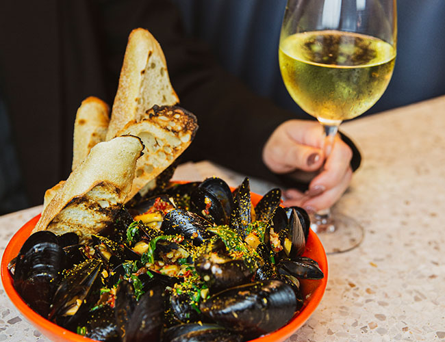 Fresh steamed mussels with a glass of white wine